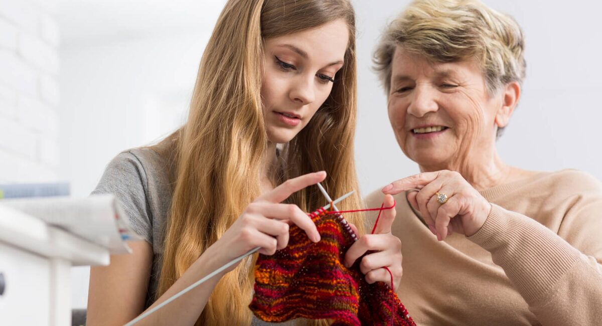 Caregiver and older woman looking at a tablet