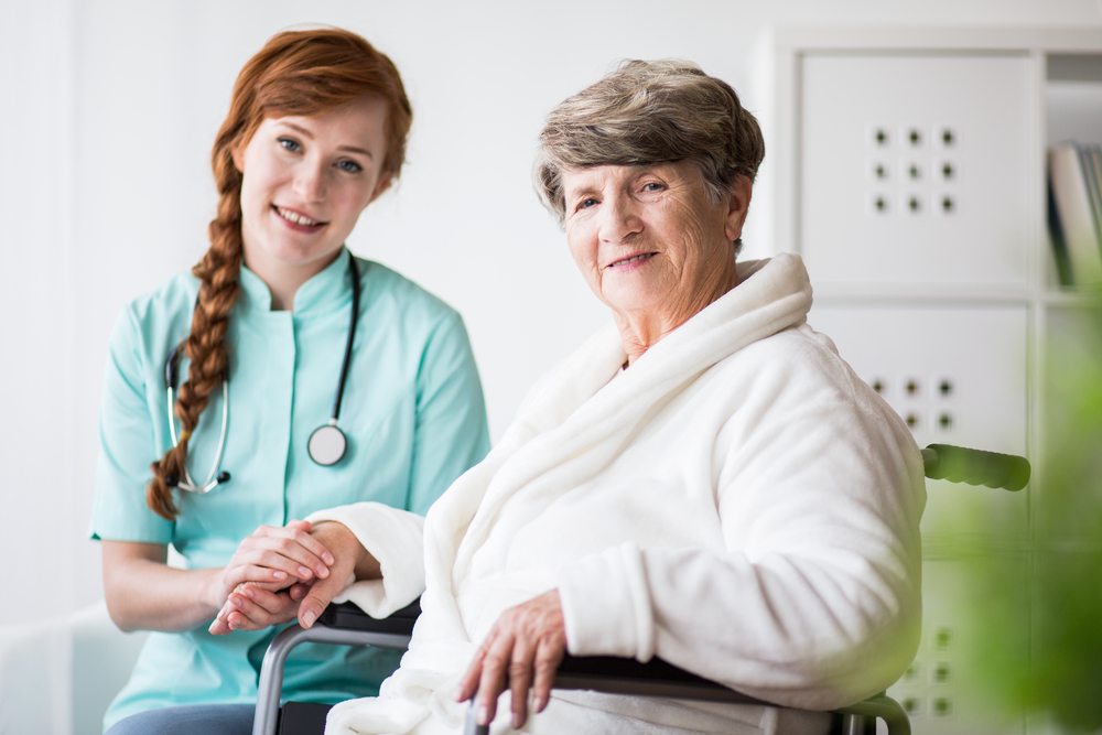 Care professional speaking with an older woman